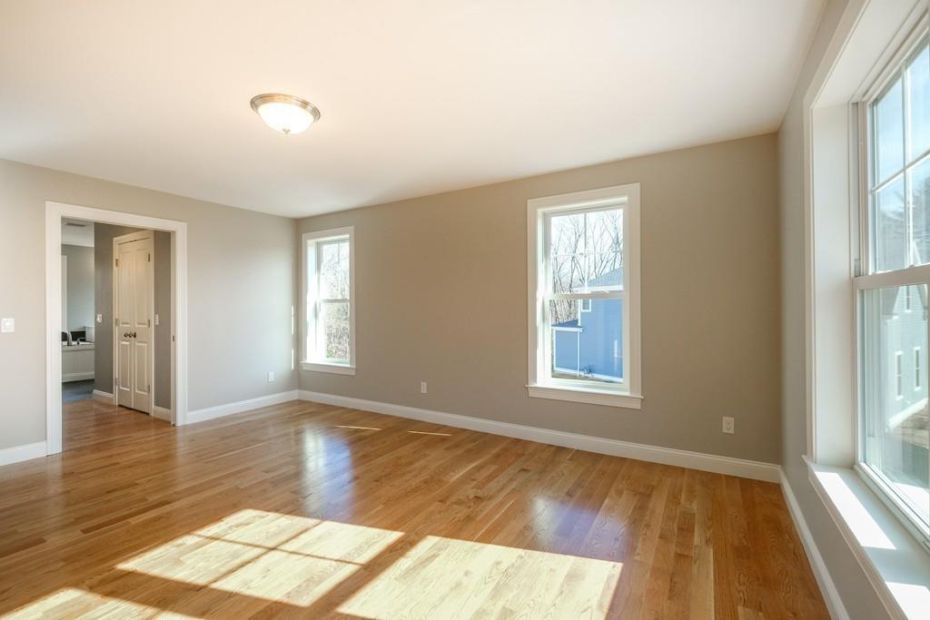 38 Michael Road Wayland, MA 01778 - Photo 13 of 27 an empty room with wooden floor and windows