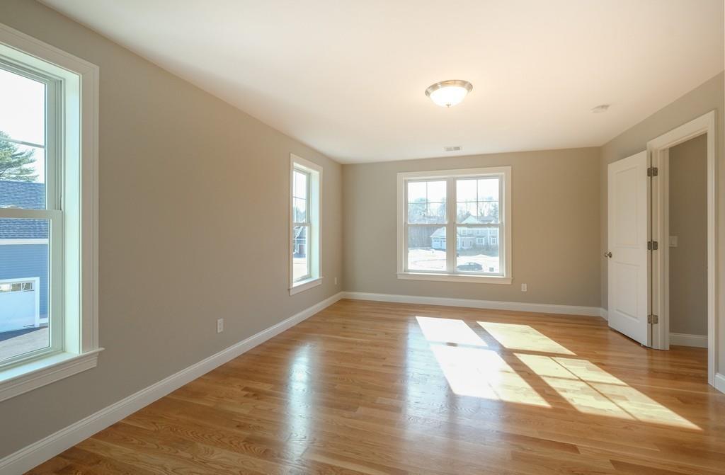 38 Michael Road Wayland, MA 01778 - Photo 18 of 27 a view of an empty room with wooden floor and a window