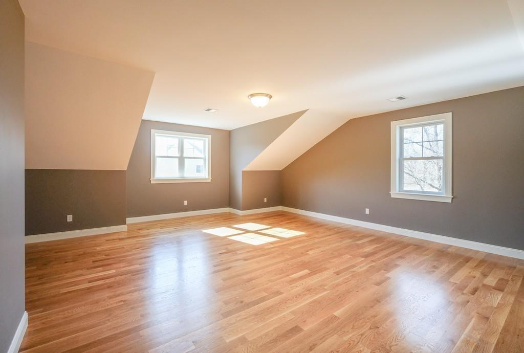 38 Michael Road Wayland, MA 01778 - Photo 22 of 27 an empty room with wooden floor and windows
