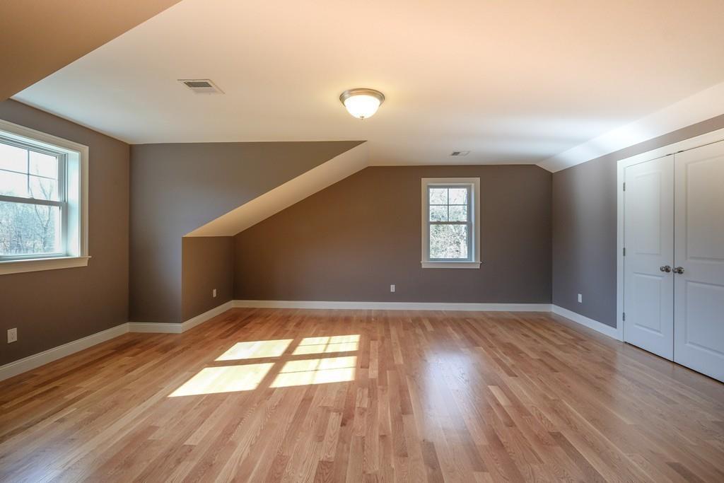38 Michael Road Wayland, MA 01778 - Photo 23 of 27 an empty room with wooden floor and windows