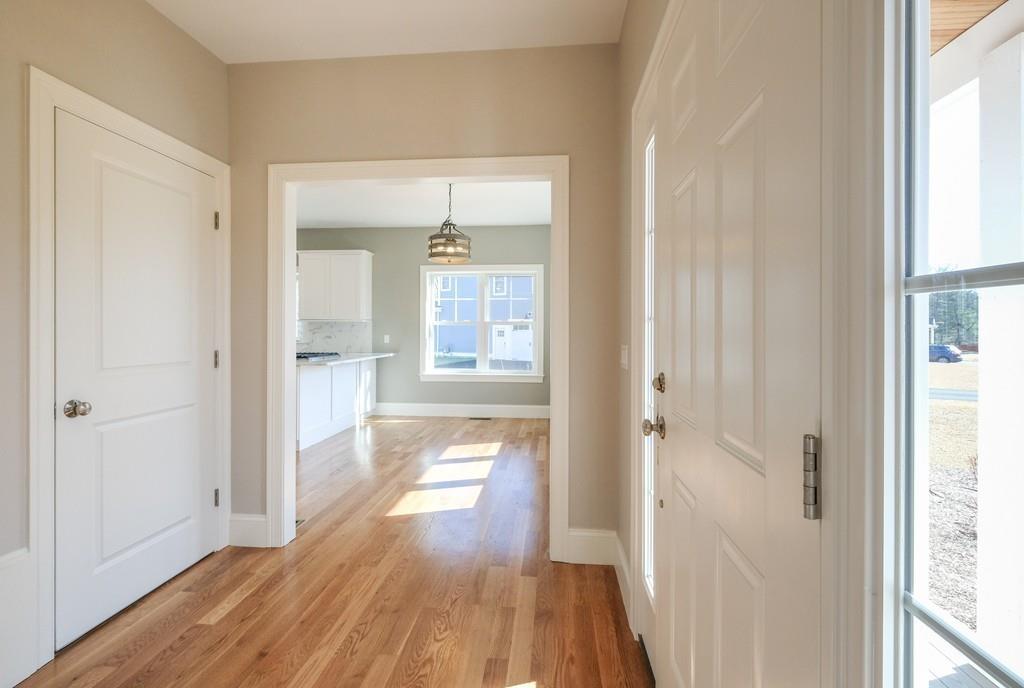 38 Michael Road Wayland, MA 01778 - Photo 4 of 27 a view of a hallway with wooden floor and a bathroom