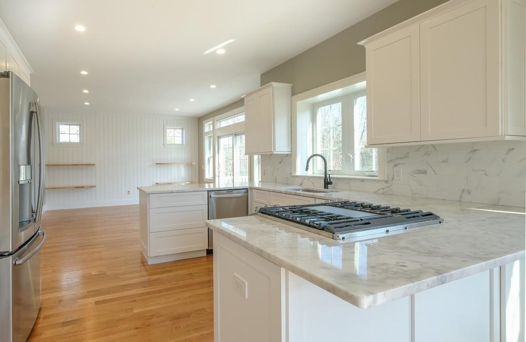 38 Michael Road Wayland, MA 01778 - Photo 5 of 27 a kitchen with stainless steel appliances granite countertop a stove a sink and a refrigerator