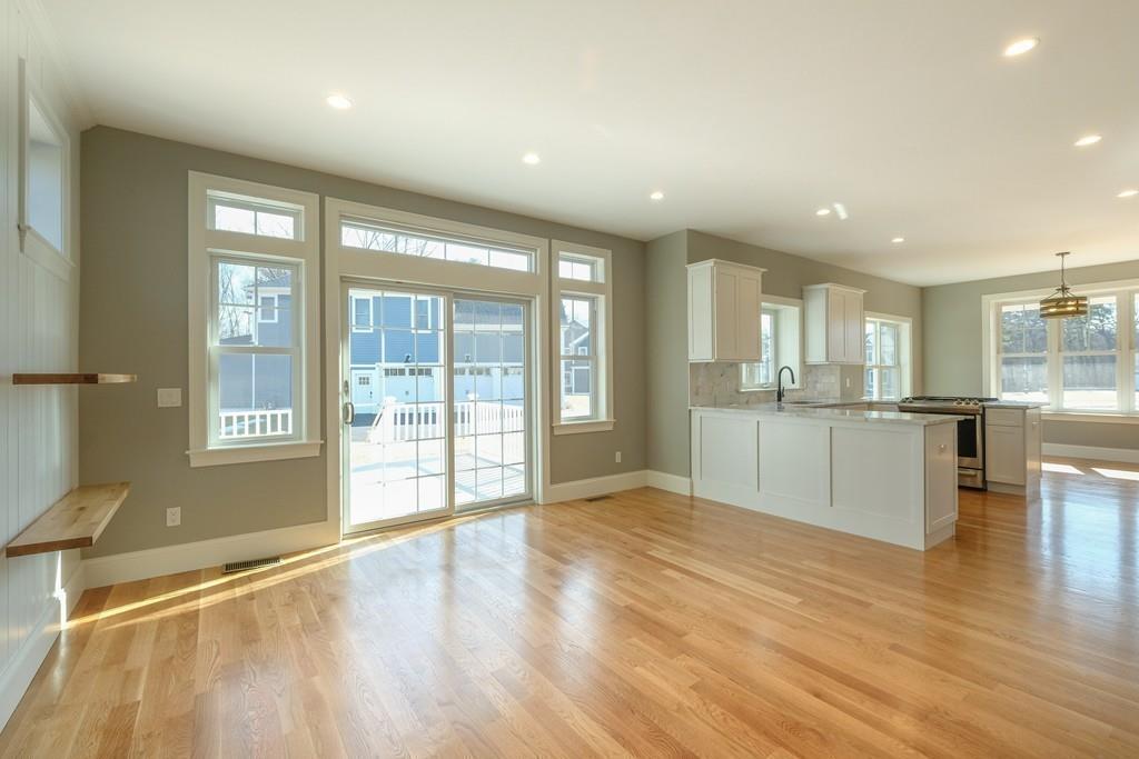 38 Michael Road Wayland, MA 01778 - Photo 6 of 27 a view of an empty room with wooden floor and a kitchen