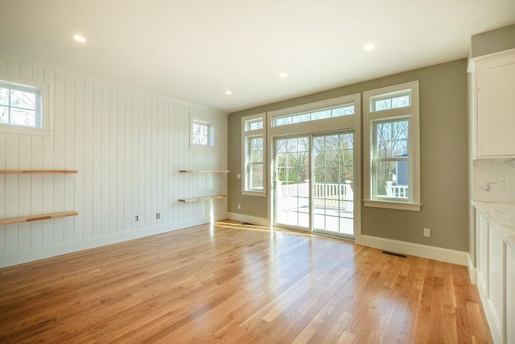 38 Michael Road Wayland, MA 01778 - Photo 7 of 27 a view of an empty room with wooden floor and a window