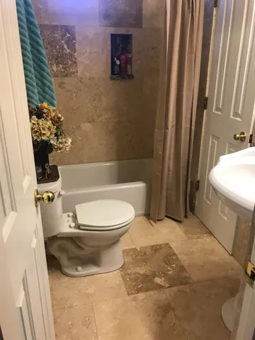 a bed sitting in a bedroom next to a lamp