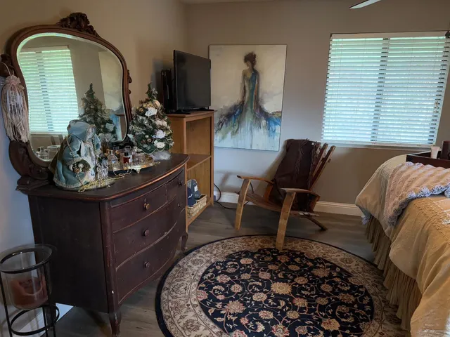 a bathroom with a granite countertop sink a mirror and shower
