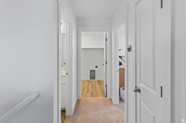 1264 West 500 South, Unit 320 Logan, UT 84321 - Photo 25 of 39 Hallway featuring neutral carpet, white trim, and multiple doorways