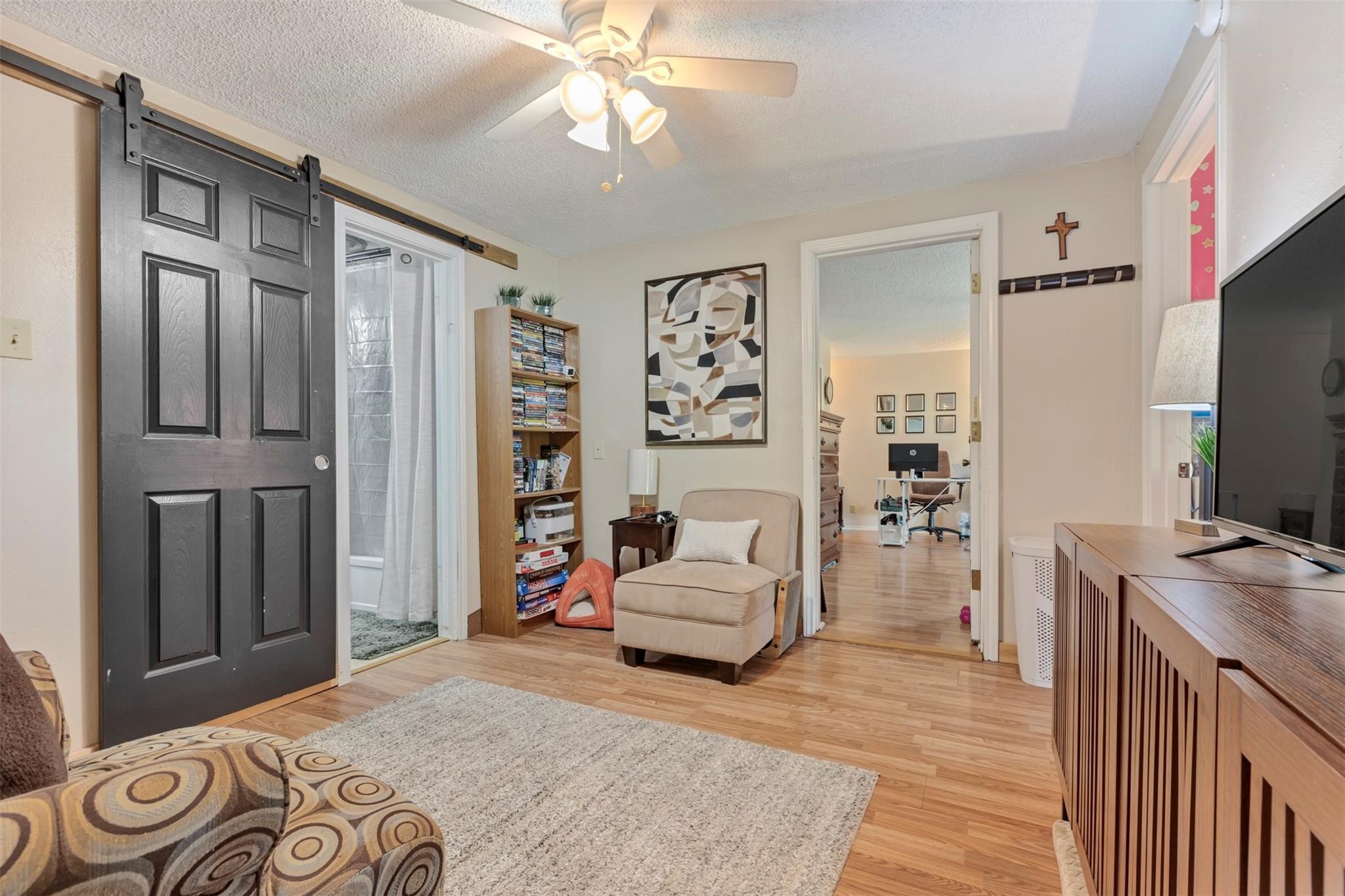 808 Morrell Street Baytown, TX 77520 - Photo 12 of 25 a bedroom with a bed furniture and a flat tv screen
