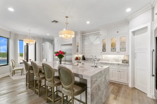 a view of a dining room and kitchen with a table chairs