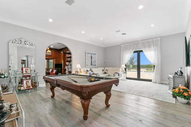a dining hall with wooden floor and breakfast area