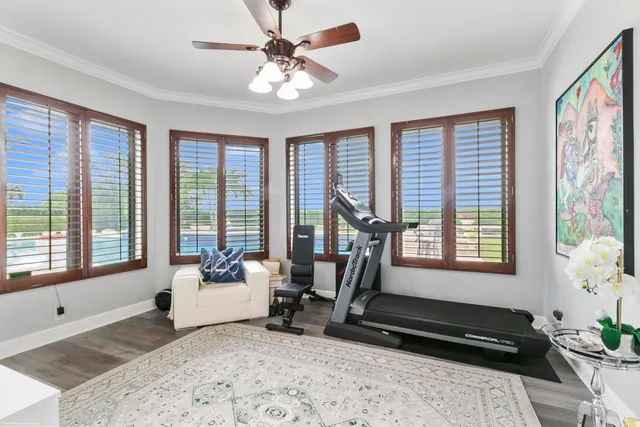 a living room with furniture and a floor to ceiling window