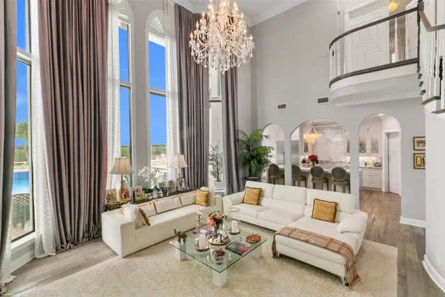 a living room with furniture and a chandelier