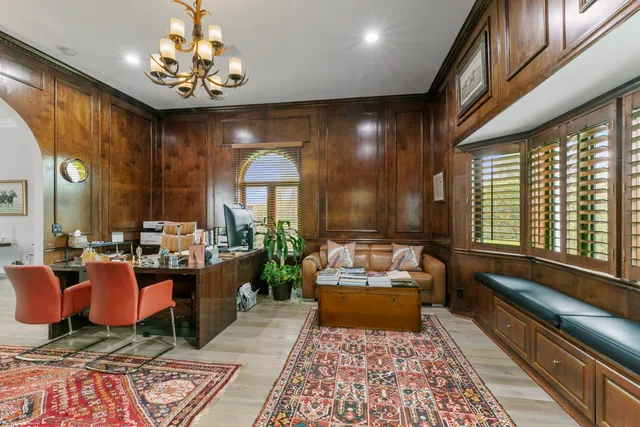 a living room with fireplace furniture and a rug