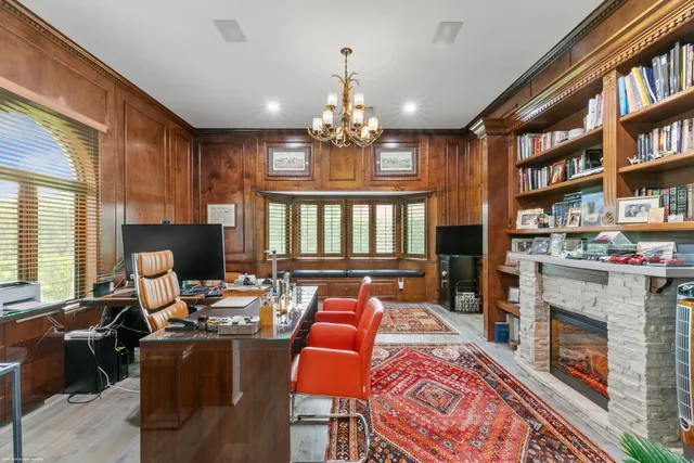 a living room with fireplace furniture and a book shelf