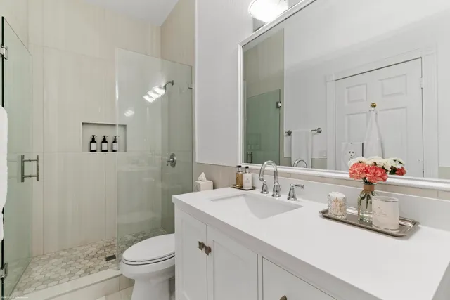 a bathroom with a sink toilet and shower