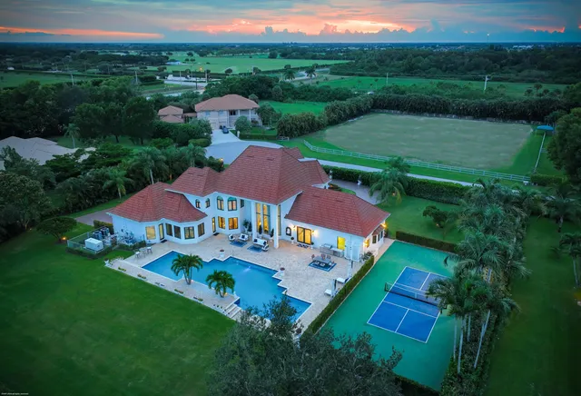 an aerial view of residential houses with outdoor space and street view