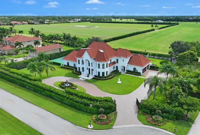 an aerial view of a house with outdoor space and a lake view