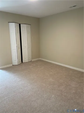 a view of an empty room and a window