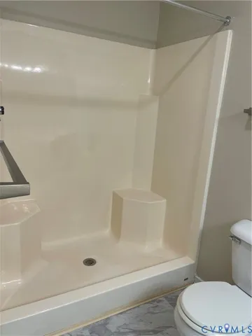 a bathroom with a bathtub and a toilet