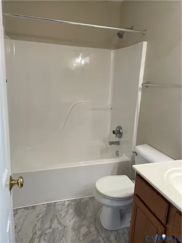 a bathroom with a toilet a sink and shower