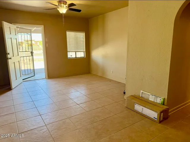 a view of a hallway with a glass door and a window
