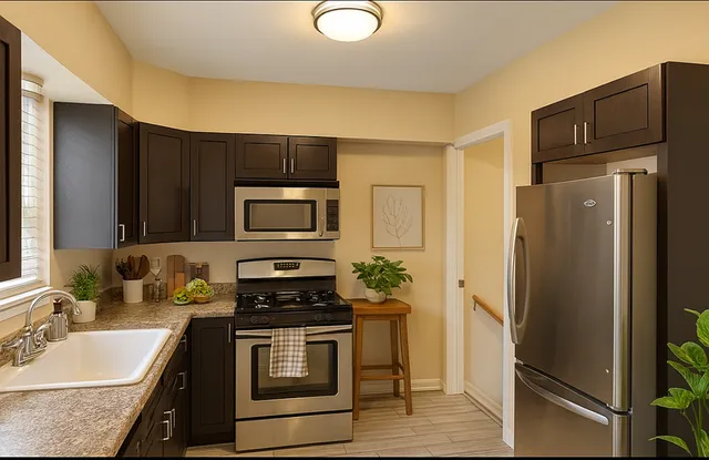 a kitchen with stainless steel appliances granite countertop a refrigerator stove and sink