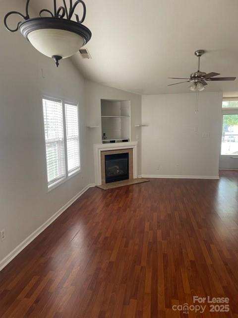 2012 Kansas City Drive Monroe, NC 28110 - Photo 13 of 14 an empty room with wooden floor a chandelier fan and windows