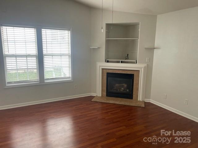 2012 Kansas City Drive Monroe, NC 28110 - Photo 14 of 14 an empty room with a fireplace and wooden floor