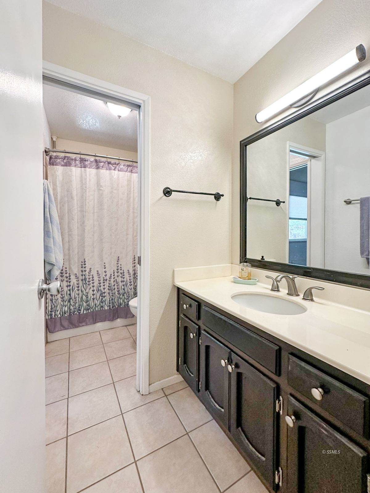 724 West Dolphin Avenue Ridgecrest, CA 93555 - Photo 26 of 50 a bathroom with a granite countertop sink a mirror and a shower