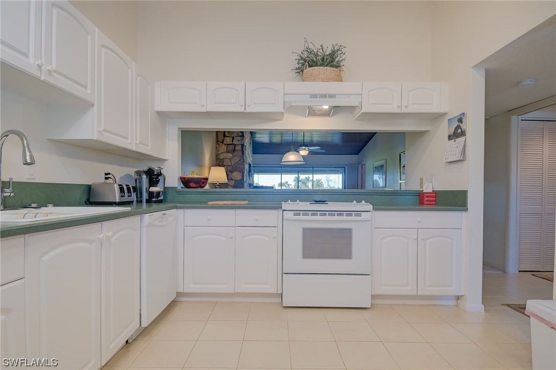 16710 Partridge Place Road, Unit 204 Fort Myers, FL 33908 - Photo 8 of 25 a kitchen with stainless steel appliances granite countertop a sink and cabinets