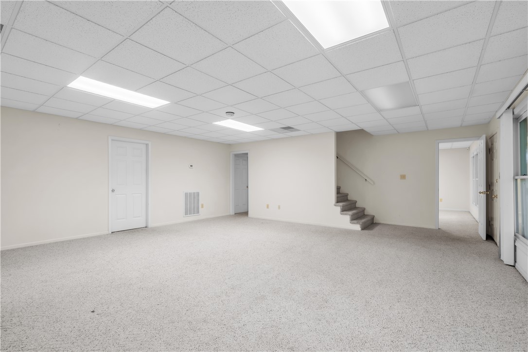 149 Inlet Pointe Drive Anderson, SC 29625 - Photo 13 of 43 A spacious, neutral-toned room offers versatile possibilities, featuring carpeted flooring and accessible stairs.