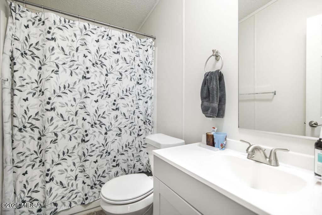 319 Pope Road Roberta, GA 31078 - Photo 24 of 42 a bathroom with a granite countertop toilet sink and mirror