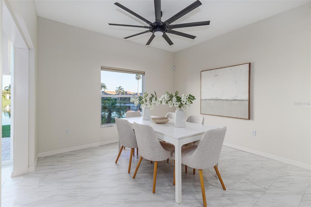 4188 Muirfield Loop Lake Wales, FL 33859 - Photo 21 of 74 a view of a dining room with furniture and a chandelier fan
