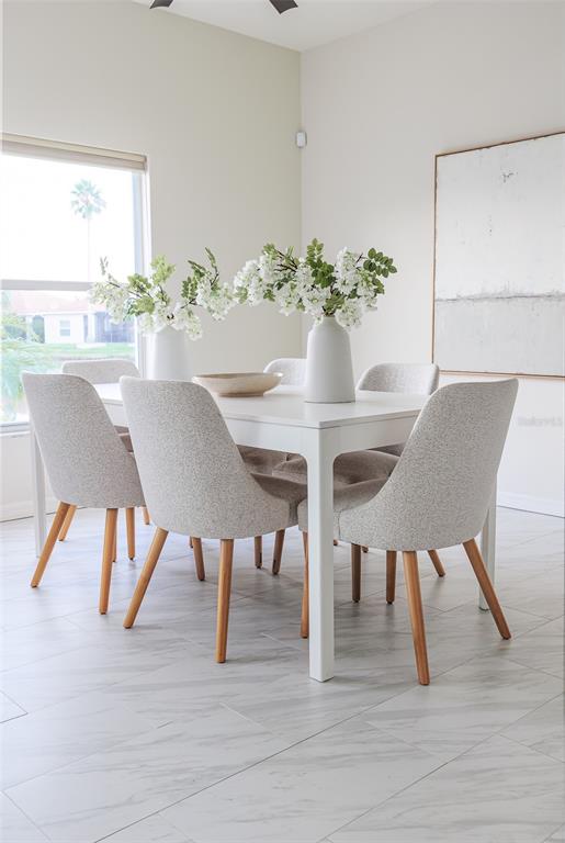 4188 Muirfield Loop Lake Wales, FL 33859 - Photo 24 of 74 a view of a dining room with furniture and wooden floor