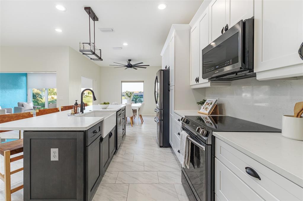 4188 Muirfield Loop Lake Wales, FL 33859 - Photo 26 of 74 a kitchen with a sink and a stove top oven
