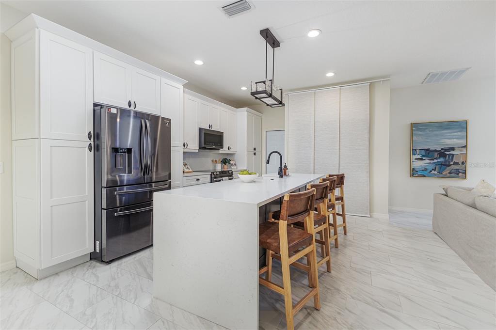 4188 Muirfield Loop Lake Wales, FL 33859 - Photo 27 of 74 a kitchen with stainless steel appliances a refrigerator and a stove top oven
