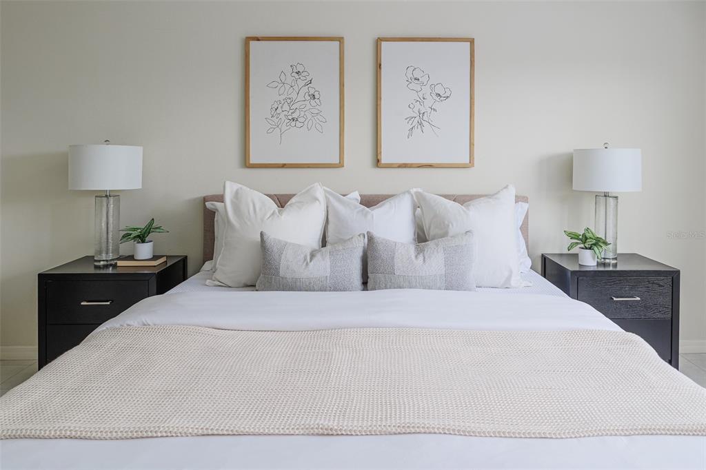 4188 Muirfield Loop Lake Wales, FL 33859 - Photo 34 of 74 a bedroom with a bed and a lamp on dresser