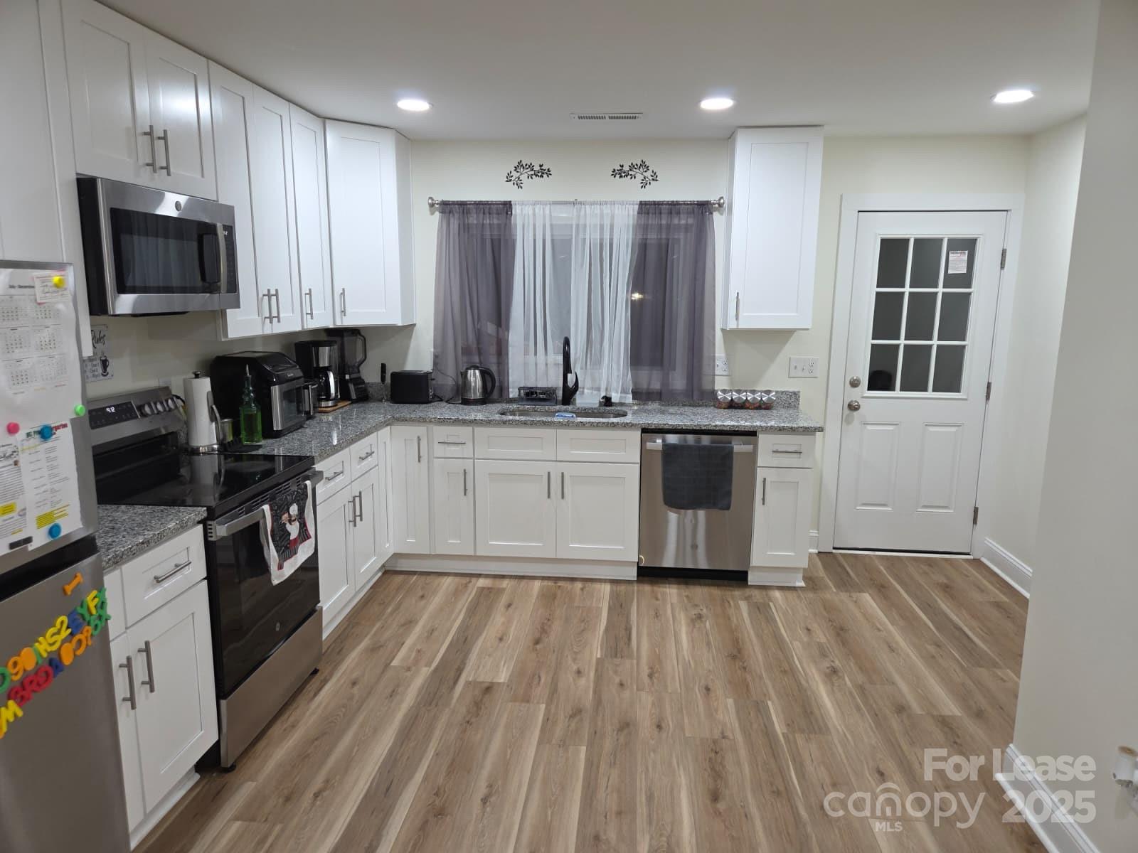 4265 Franklin Community Center Road Salisbury, NC 28144 - Photo 2 of 9 a kitchen with stainless steel appliances granite countertop a stove a sink and a microwave