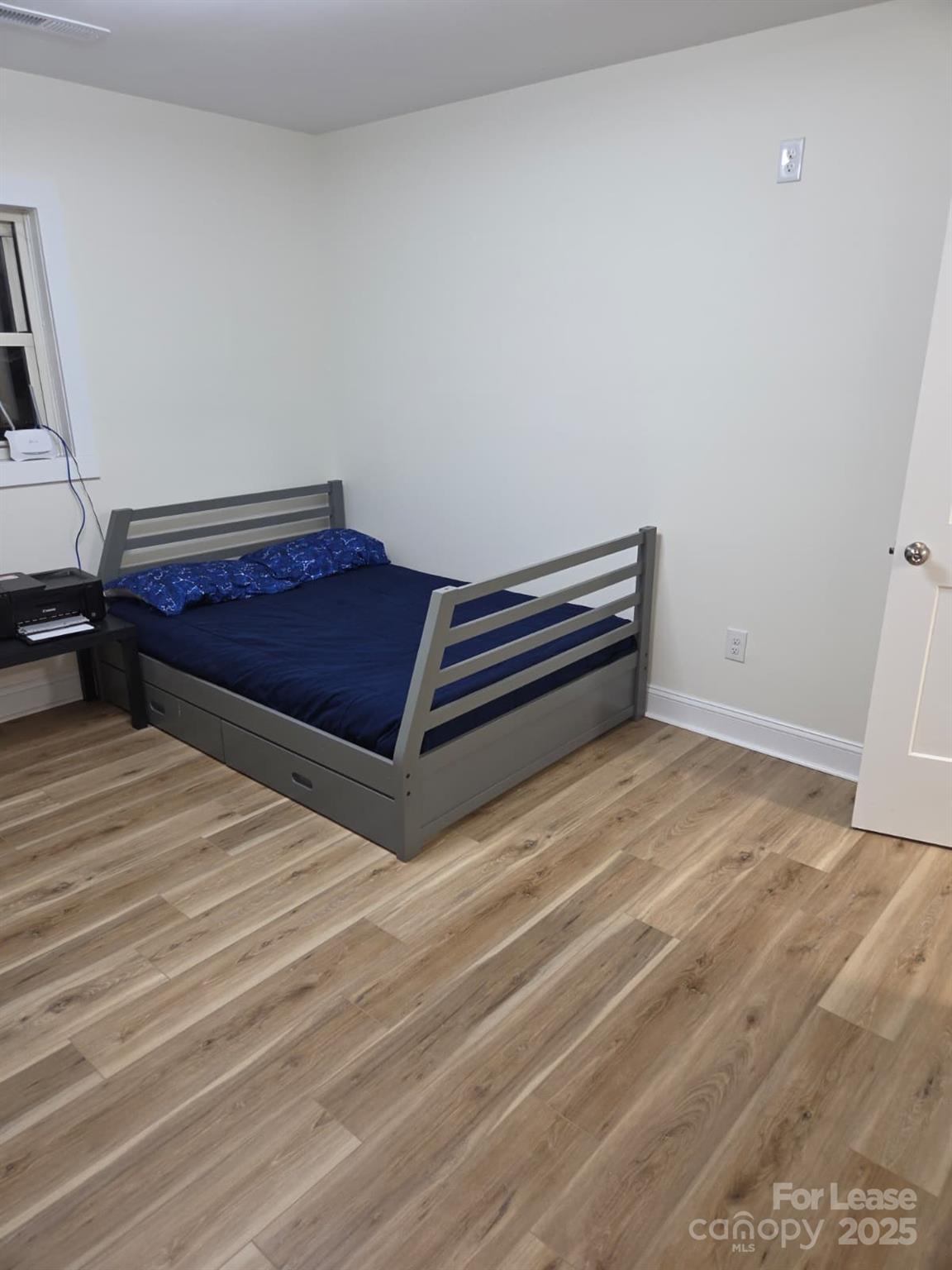 4265 Franklin Community Center Road Salisbury, NC 28144 - Photo 5 of 9 a room with a bed and wooden floor