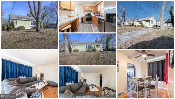 a view of living room kitchen with stainless steel appliances kitchen island granite countertop a couch chairs and a stove