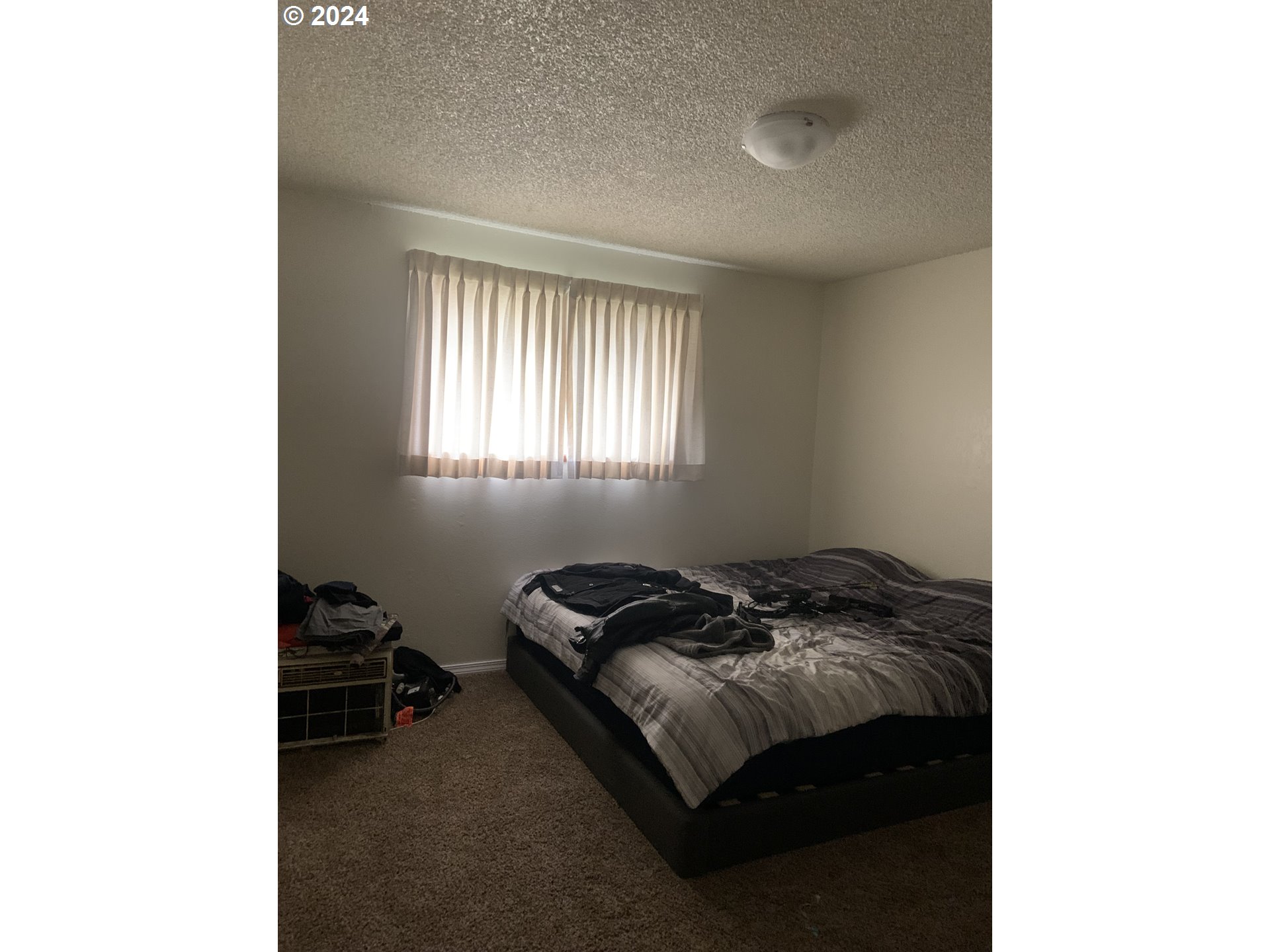 6757 Main Street Springfield, OR 97478 - Photo 8 of 22 a bedroom with a bed and a window