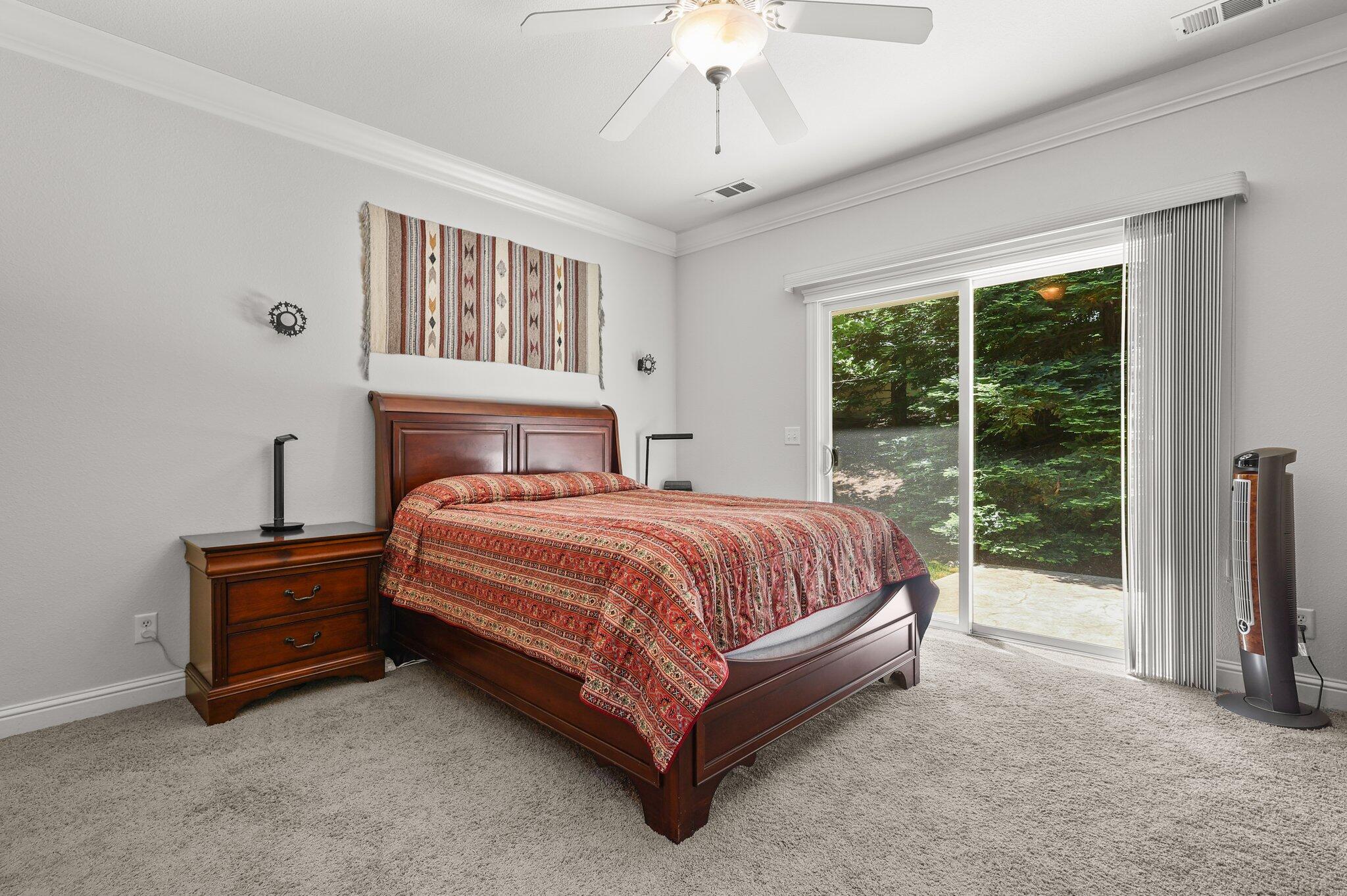 955 Leisha Lane Redding, CA 96001 - Photo 11 of 36 a spacious bedroom with a bed and a large window