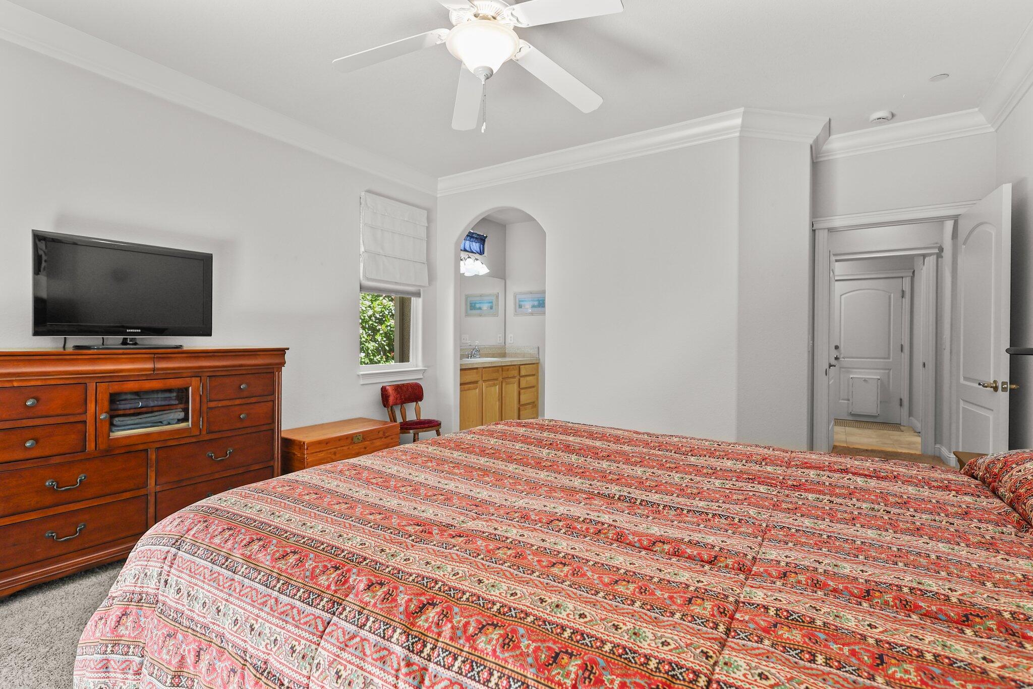 955 Leisha Lane Redding, CA 96001 - Photo 13 of 36 a bedroom with a bed and a flat screen tv