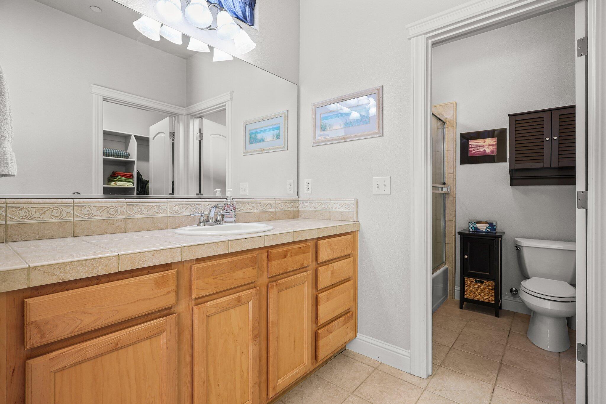 955 Leisha Lane Redding, CA 96001 - Photo 14 of 36 a bathroom with a toilet sink and mirror