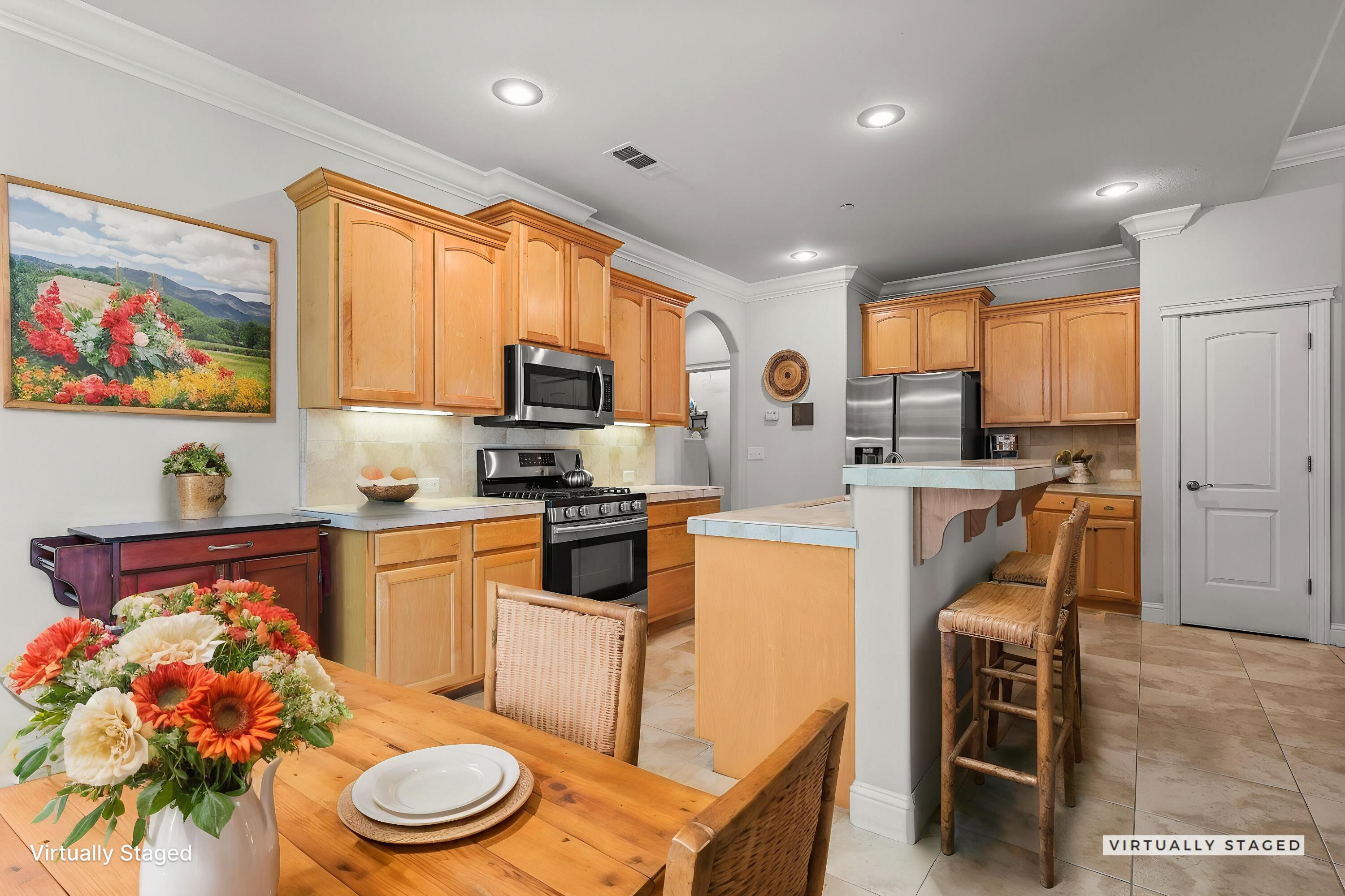 955 Leisha Lane Redding, CA 96001 - Photo 2 of 36 a kitchen with stainless steel appliances a microwave a stove a sink dishwasher a dining table and chairs with wooden floor