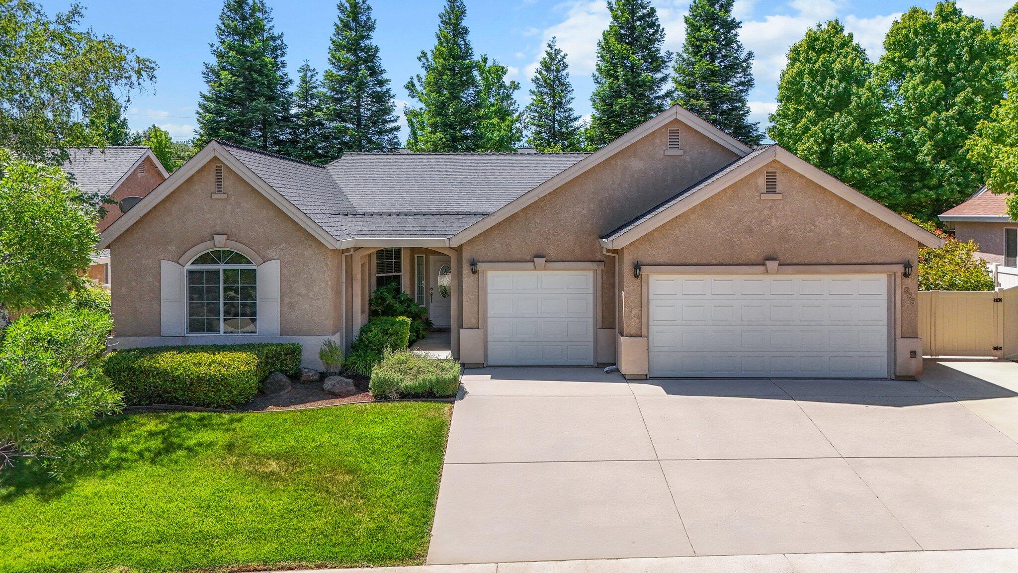 955 Leisha Lane Redding, CA 96001 - Photo 33 of 36 a view of a house with a small yard plants and large tree