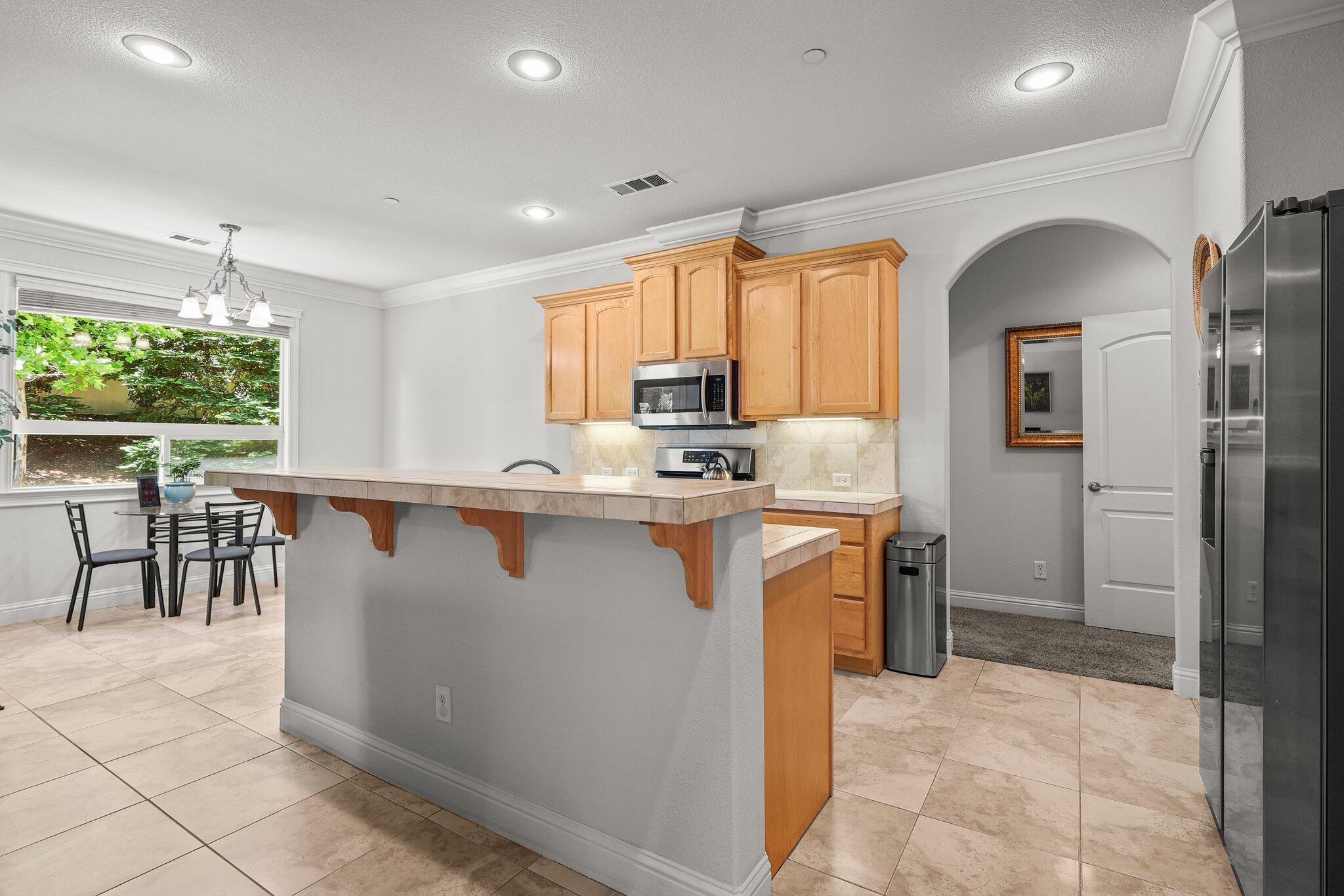 955 Leisha Lane Redding, CA 96001 - Photo 5 of 36 a kitchen with stainless steel appliances granite countertop a stove refrigerator sink and cabinets