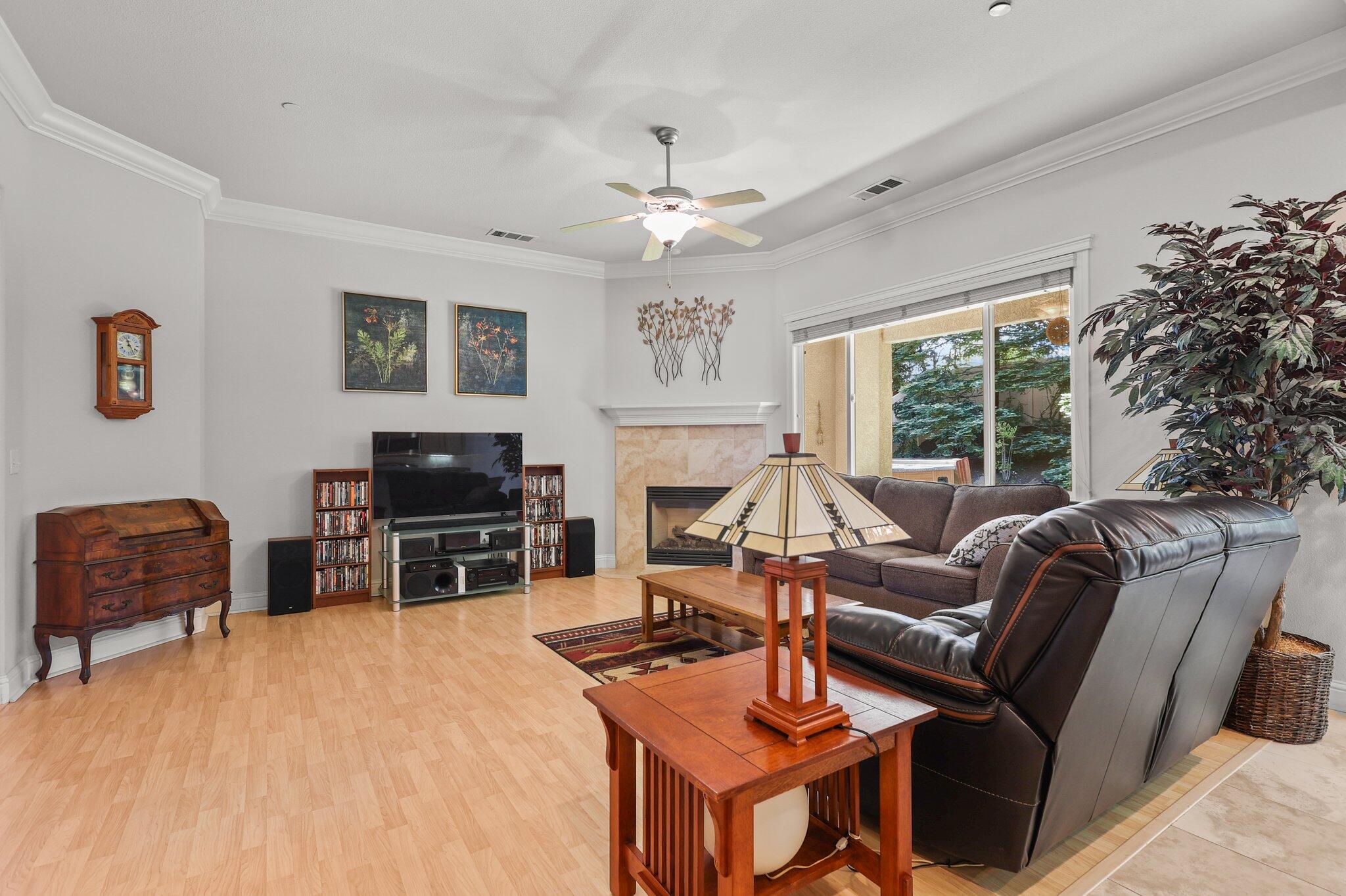 955 Leisha Lane Redding, CA 96001 - Photo 8 of 36 a living room with furniture a fireplace and a flat screen tv