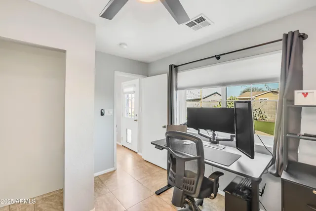 a view of a workspace with furniture and a gate