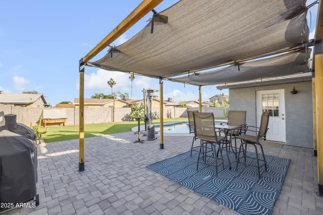 a view of a patio with table and chairs